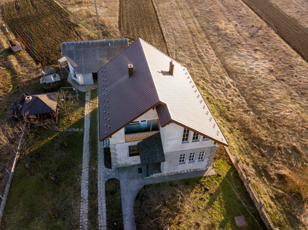 Aerial view of new residential house cottage with shingle roof.