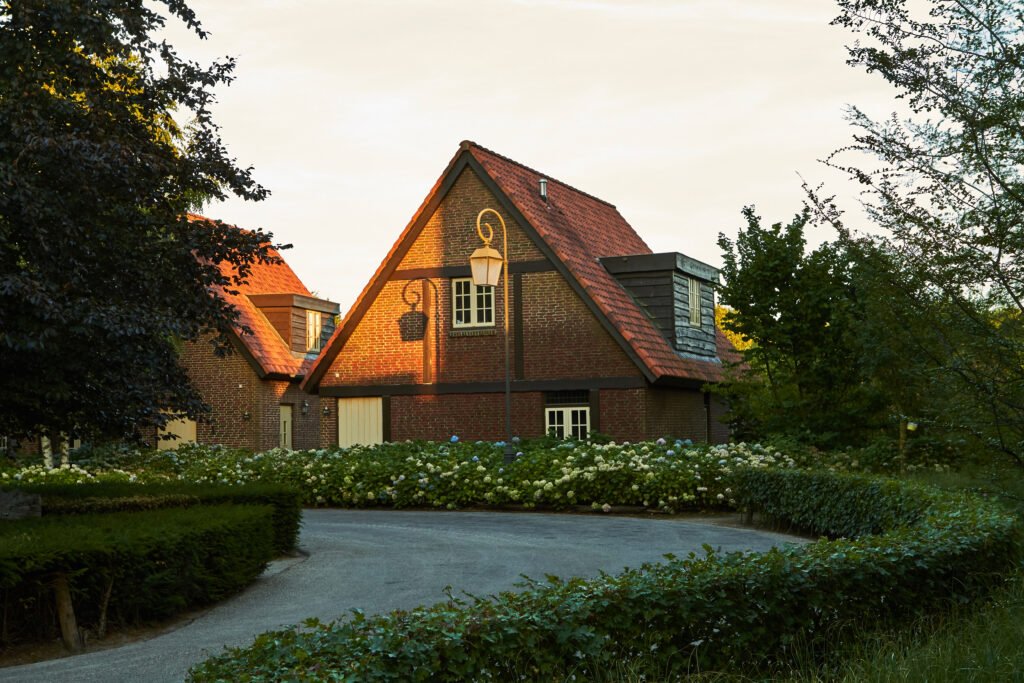 Beautiful scene of houses surrounded by forests at sunset. Netherlands, July 2018